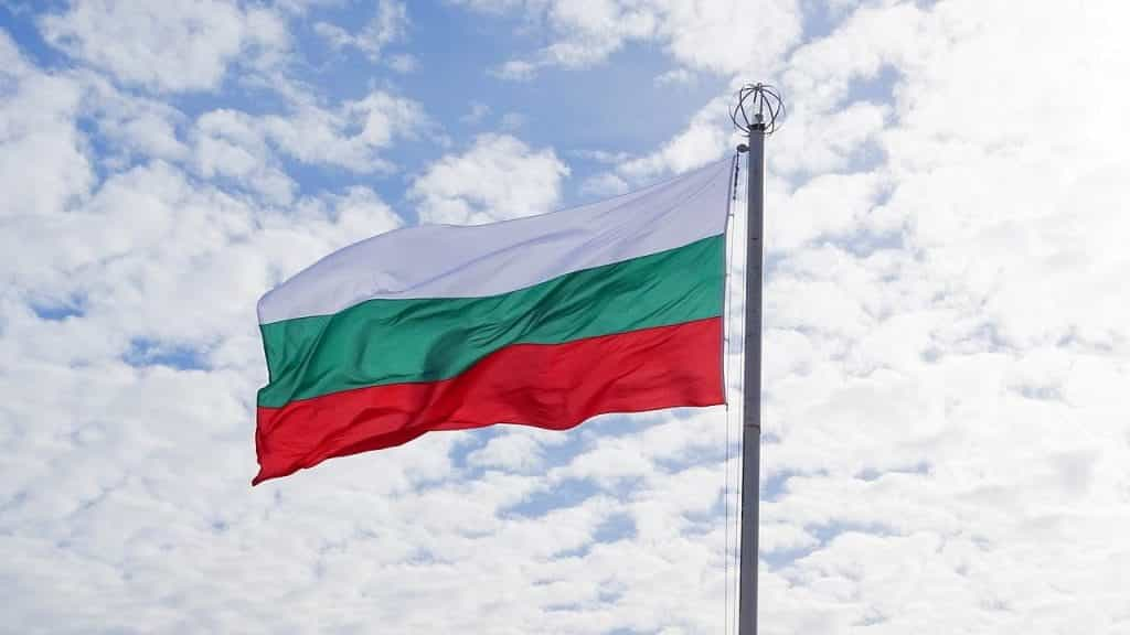 The Bulgarian flag flying from a flagpole.