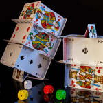 Stacks of cards next to multi-colored dice.