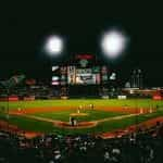 A packed baseball stadium in San Francisco, California at night.