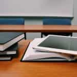 Books and an iPad on a school desk.