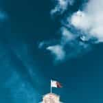 The flag of Malta flying over Valetta city.