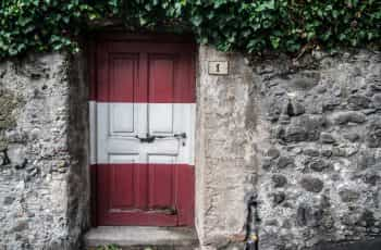 A door painted in the colors of the Austrian flag.