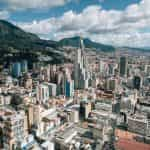 High rise buildings in the city of Bogotá, Colombia, with mountains in the background.