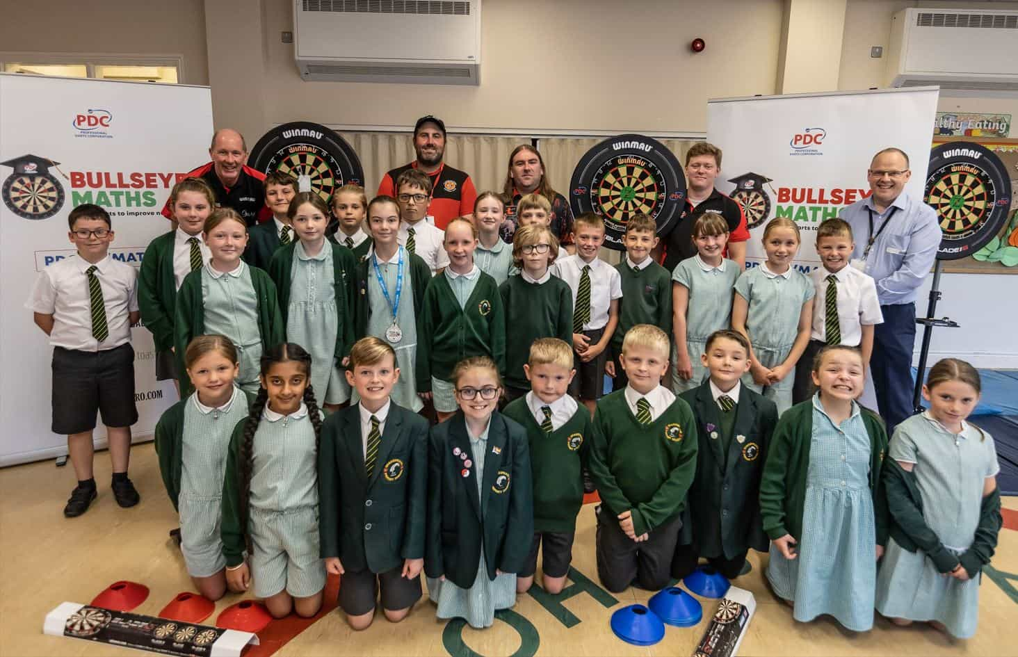 Pro darts players in a school classroom following a ‘Bullseye Maths’ session.